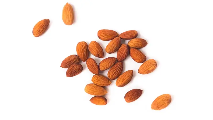 overhead shot of almonds on white background