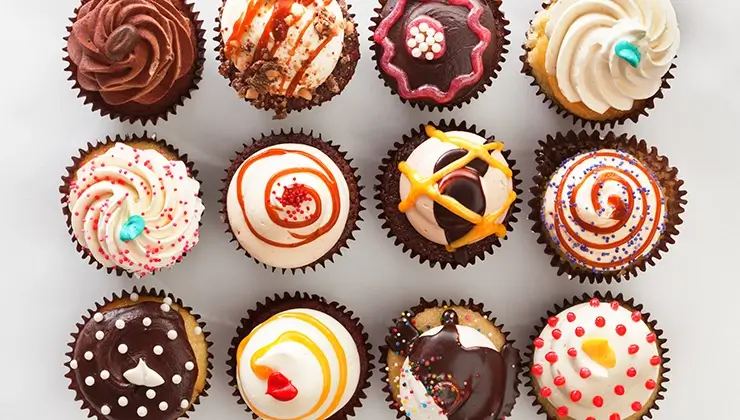 overhead shot of cupcakes on a gray background
