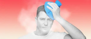 Man holding ice pack to head with steam coming his head and neck
